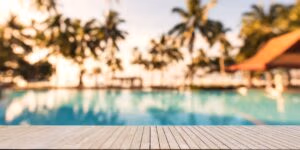 a recently washed pool deck with palm trees in the background