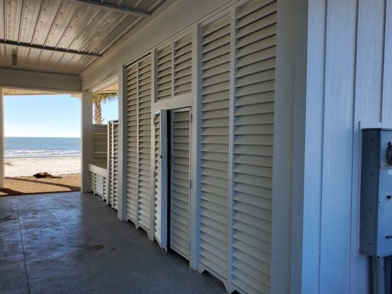 Clean white louvered shutters on a beachfront building exterior on St. George Island, FL