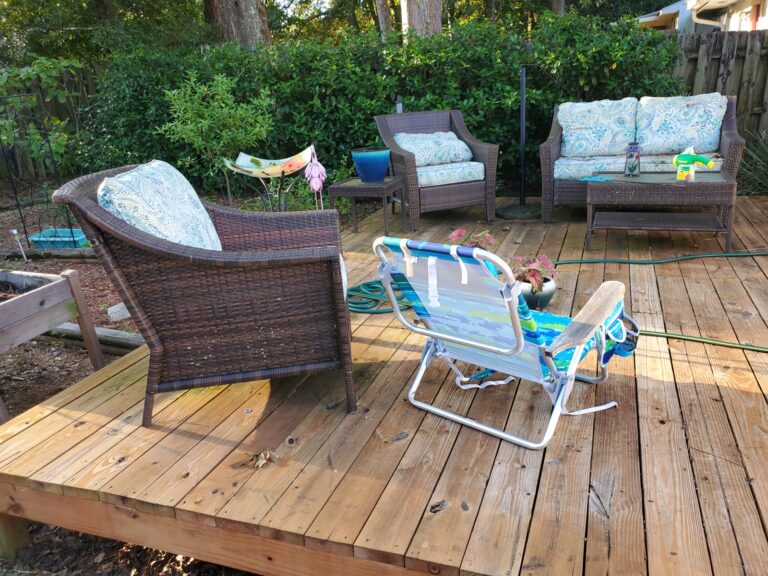 Clean wood deck after pressure washing with patio furniture in Tallahassee, FL