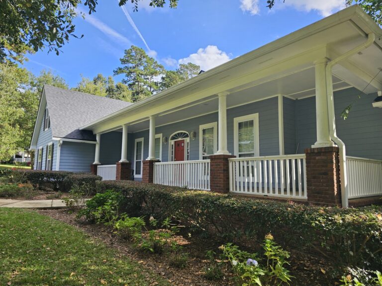 Clean home exterior with bright white porch and gutters in Tallahassee, FL
