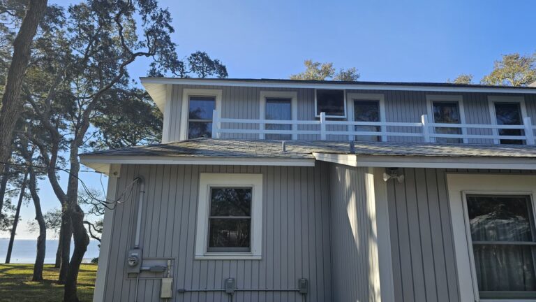 Clean gray home exterior after soft wash service in Panacea, FL