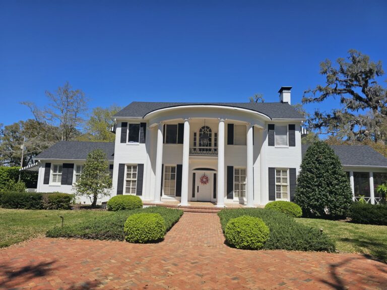 Clean white colonial home exterior after house washing in Tallahassee, FL