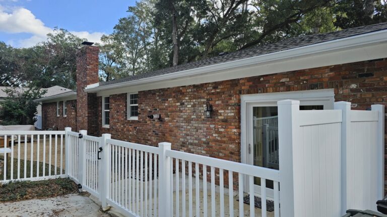Clean brick home exterior with white vinyl fence in Killearn Estates, Tallahassee, FL