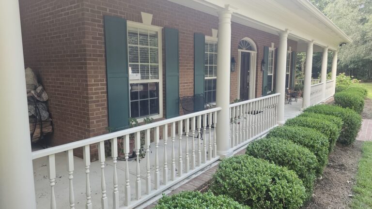 Rosehill and Bobbin Brook Pressure Washing Services 2 Clean brick home front porch with white railings after washing in Rosehill, Tallahassee, FL