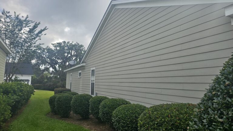 Clean gray house siding after soft wash treatment in SouthWood, Tallahassee, FL