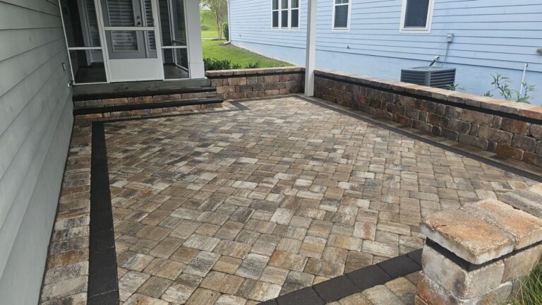 Clean paver patio and stone wall after pressure washing in SouthWood, Tallahassee, FL